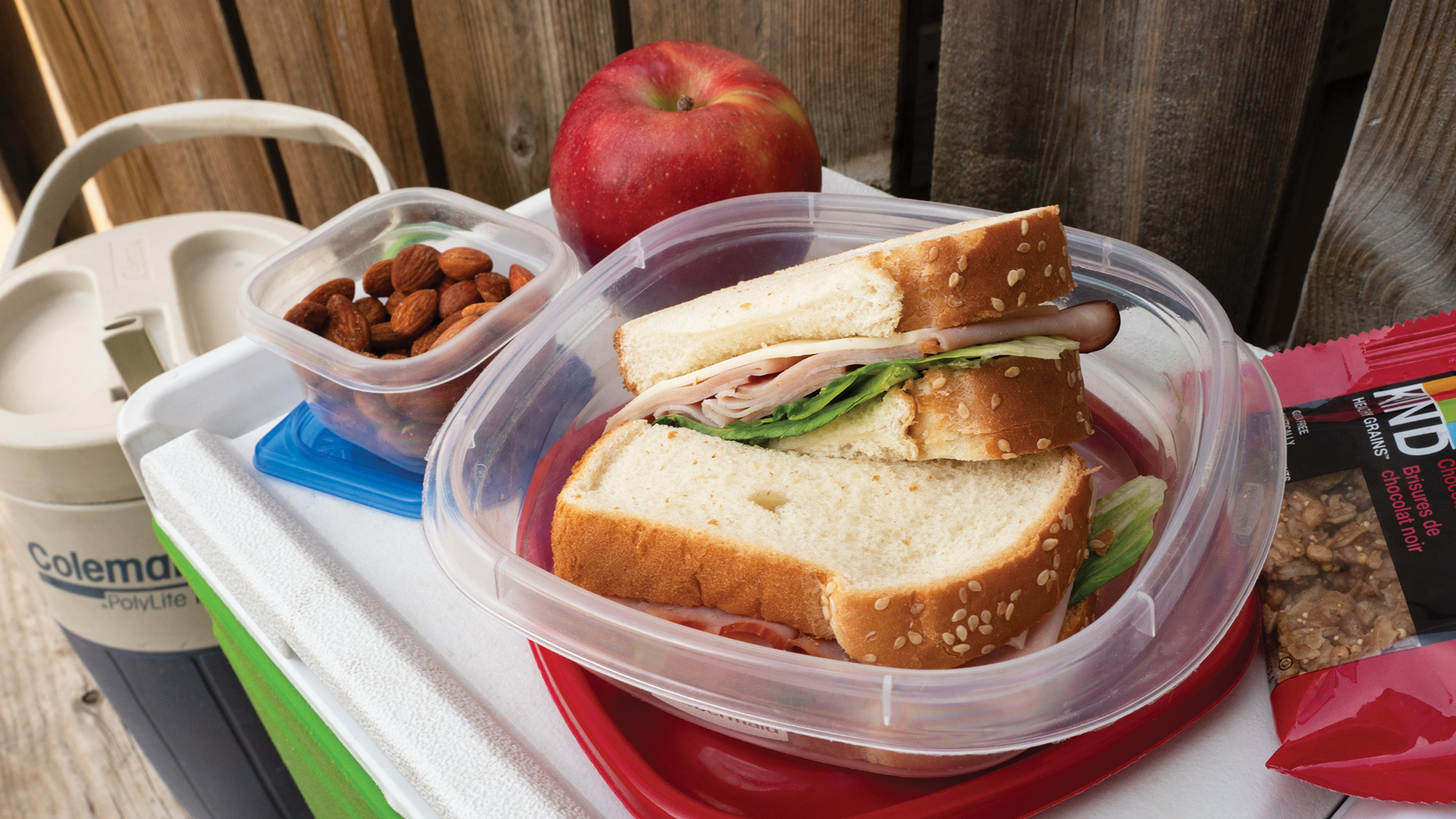 container with Sandwich and an apple